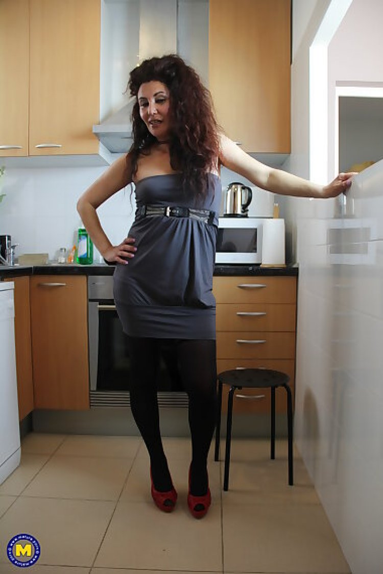 Naughty spanish housewife playing in her kitchen