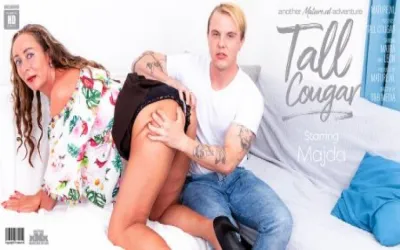 Tall cougar seduces a young guy